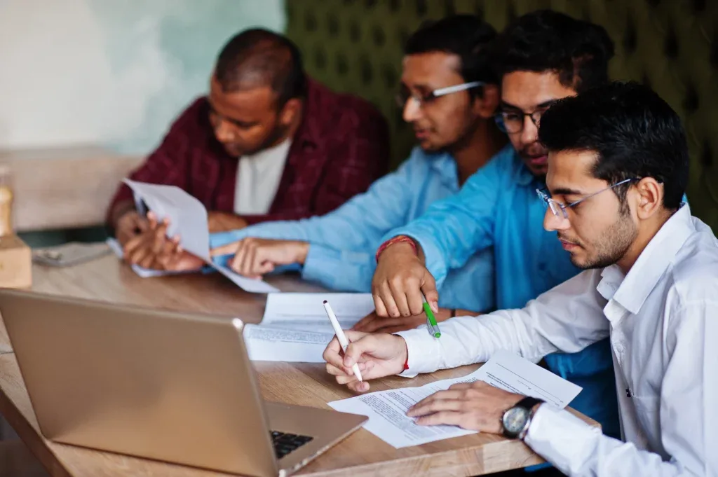 group four south asian men s posed business meeting cafe indians together sign important documents contract study work 1024x681 e43984d2 1024
